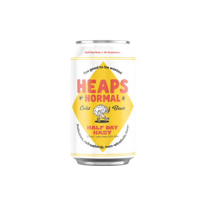 Can of 'Heaps Normal' non-alcoholic beer with a yellow label on a white background
