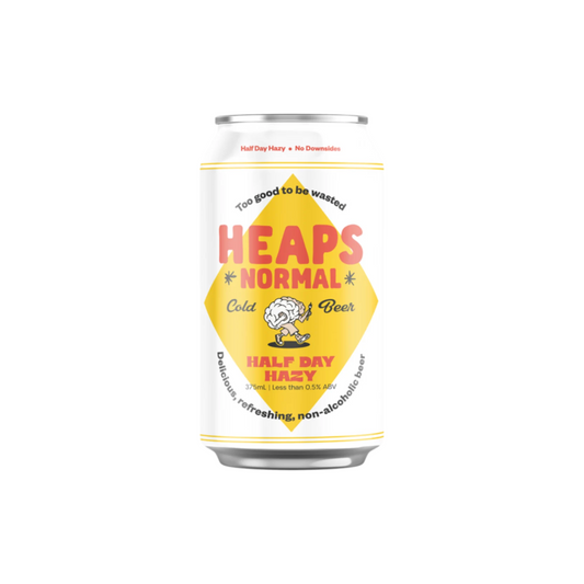 Can of 'Heaps Normal' non-alcoholic beer with a yellow label on a white background