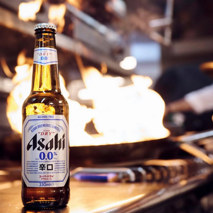 Asahi beer bottle on a bar counter with a blurred background